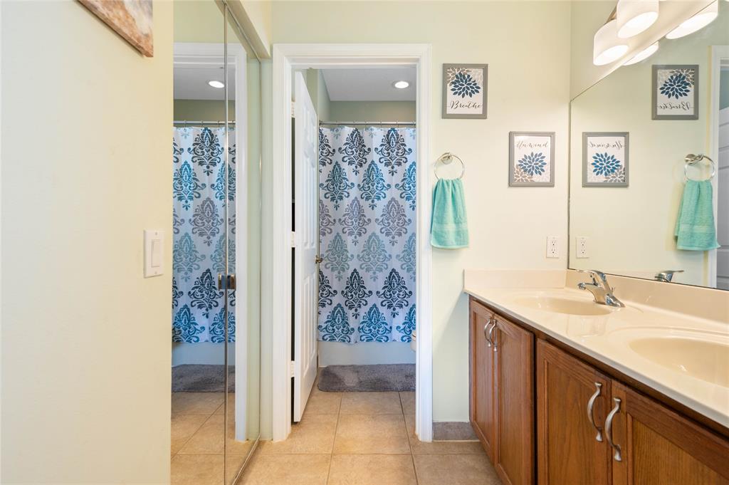 3067 Laurel Ridge Circle Riviera Beach, FL 33404 - Photo 19 of 27 a bathroom with a granite countertop sink a mirror and shower