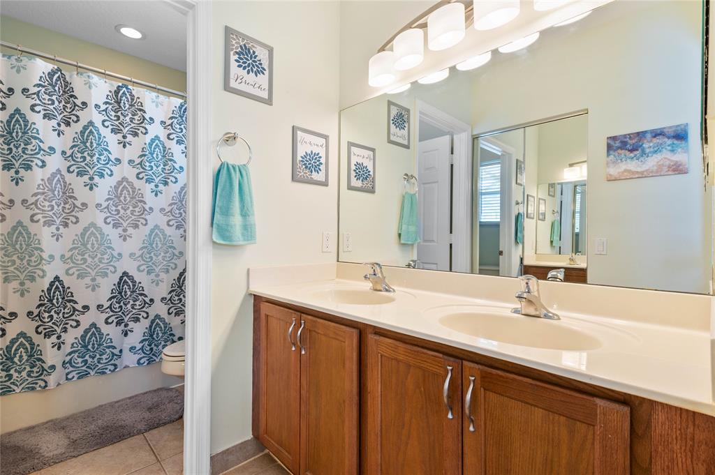 3067 Laurel Ridge Circle Riviera Beach, FL 33404 - Photo 20 of 27 a bathroom with a sink vanity and a mirror