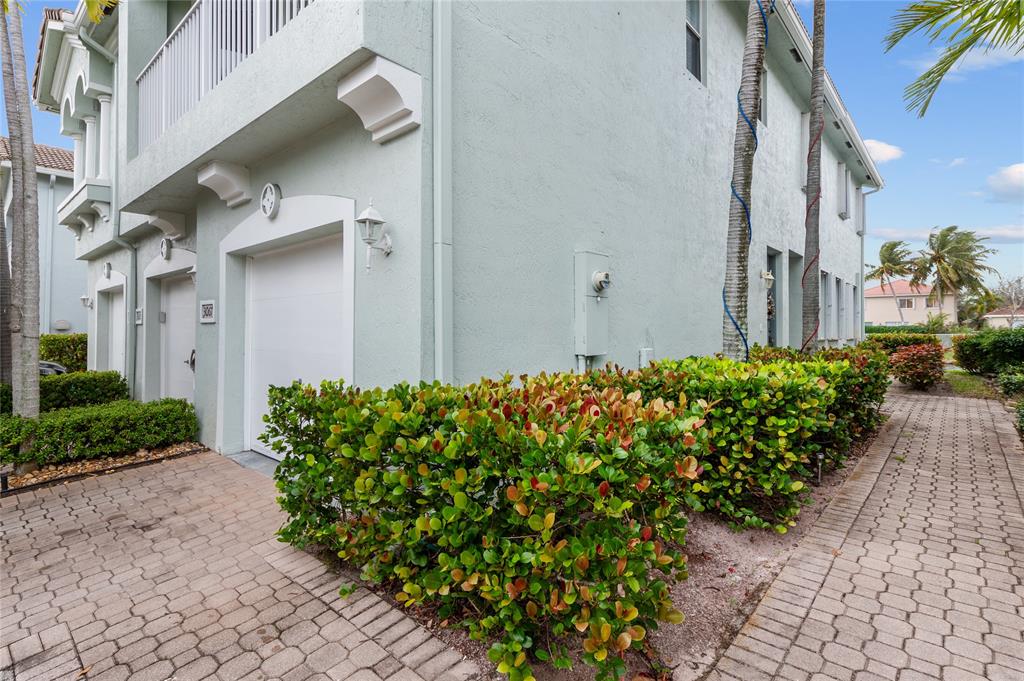 3067 Laurel Ridge Circle Riviera Beach, FL 33404 - Photo 2 of 27 a front view of a house with a yard