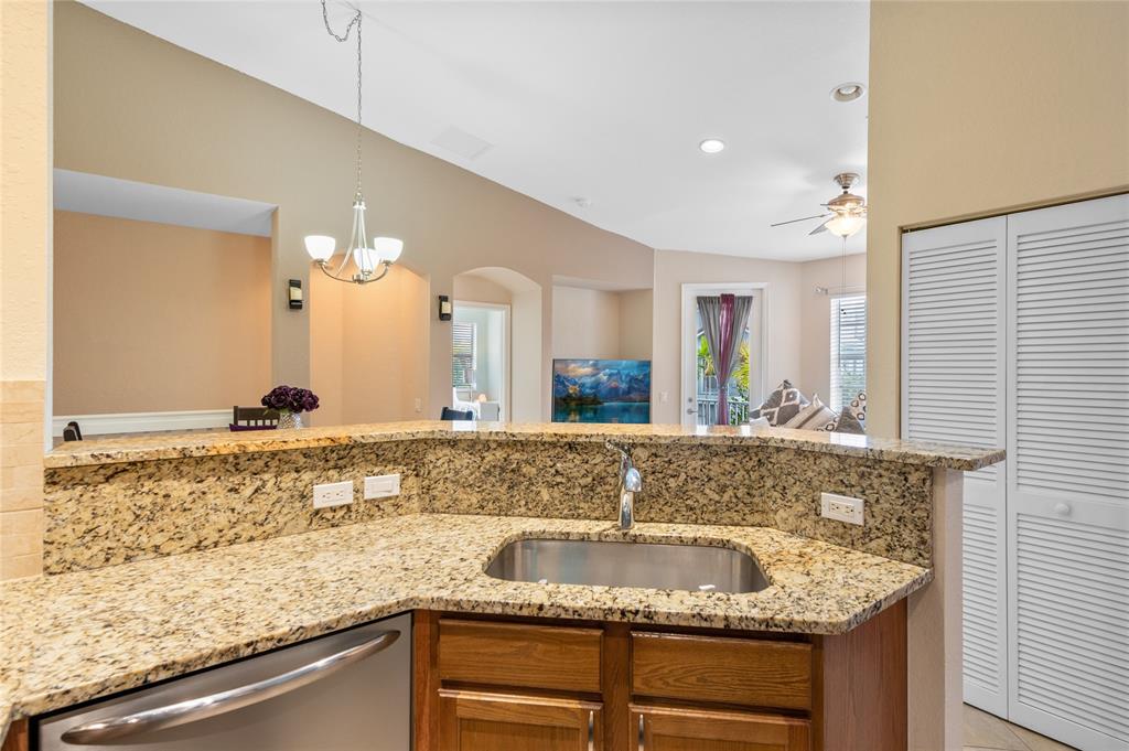 3067 Laurel Ridge Circle Riviera Beach, FL 33404 - Photo 22 of 27 a bathroom with a granite countertop sink and a mirror