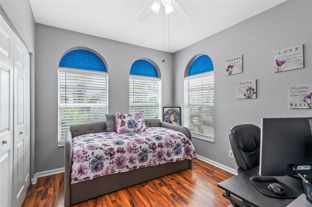 3067 Laurel Ridge Circle Riviera Beach, FL 33404 - Photo 24 of 27 a bedroom with bed and a window