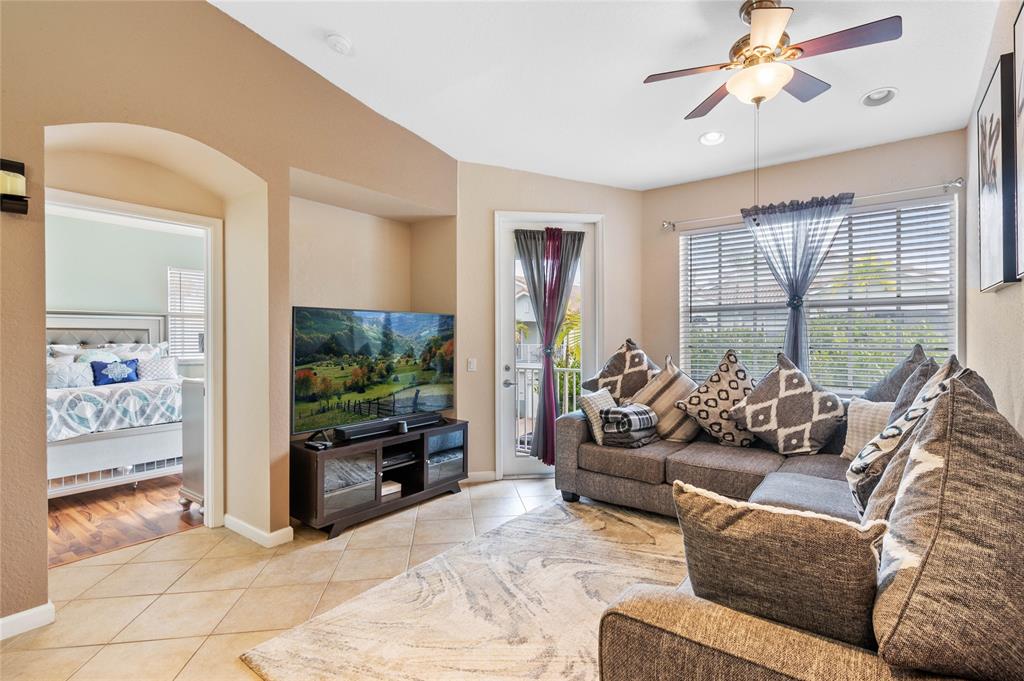 3067 Laurel Ridge Circle Riviera Beach, FL 33404 - Photo 8 of 27 a living room with furniture and a flat screen tv