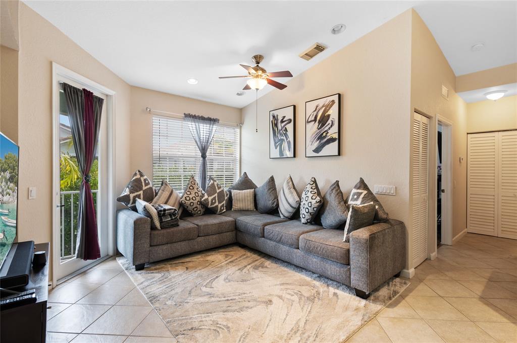 3067 Laurel Ridge Circle Riviera Beach, FL 33404 - Photo 9 of 27 a living room with furniture and large window