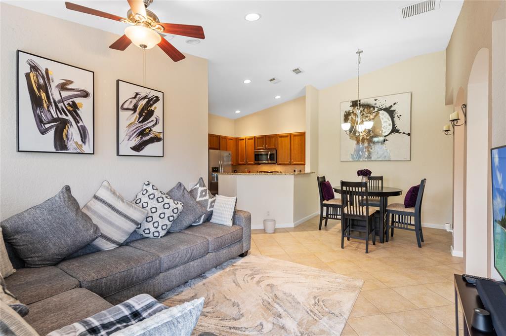 3067 Laurel Ridge Circle Riviera Beach, FL 33404 - Photo 10 of 27 a living room with furniture kitchen view and a chandelier