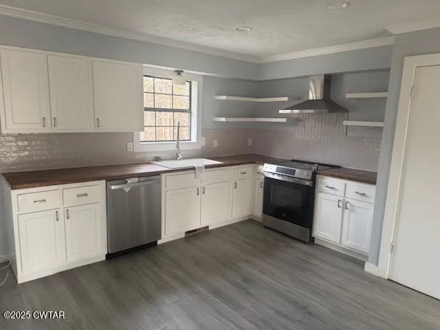 a kitchen with a white cabinets a sink dishwasher and a stove