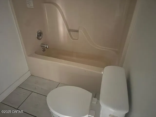 a bathroom with a toilet and bathtub