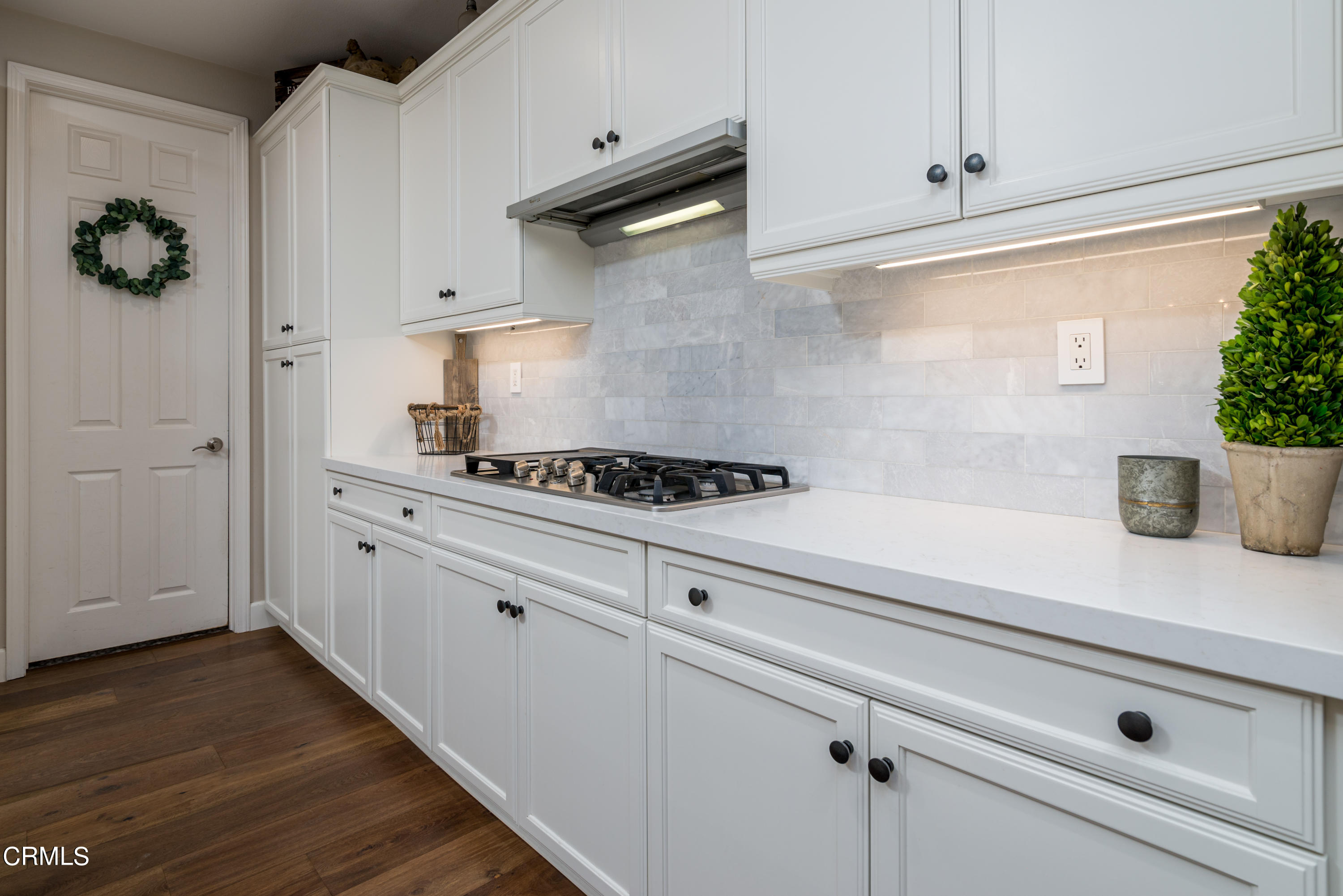 3064 White Rock Road Camarillo, CA 93012 - Photo 11 of 47 a kitchen with white cabinets and a stove