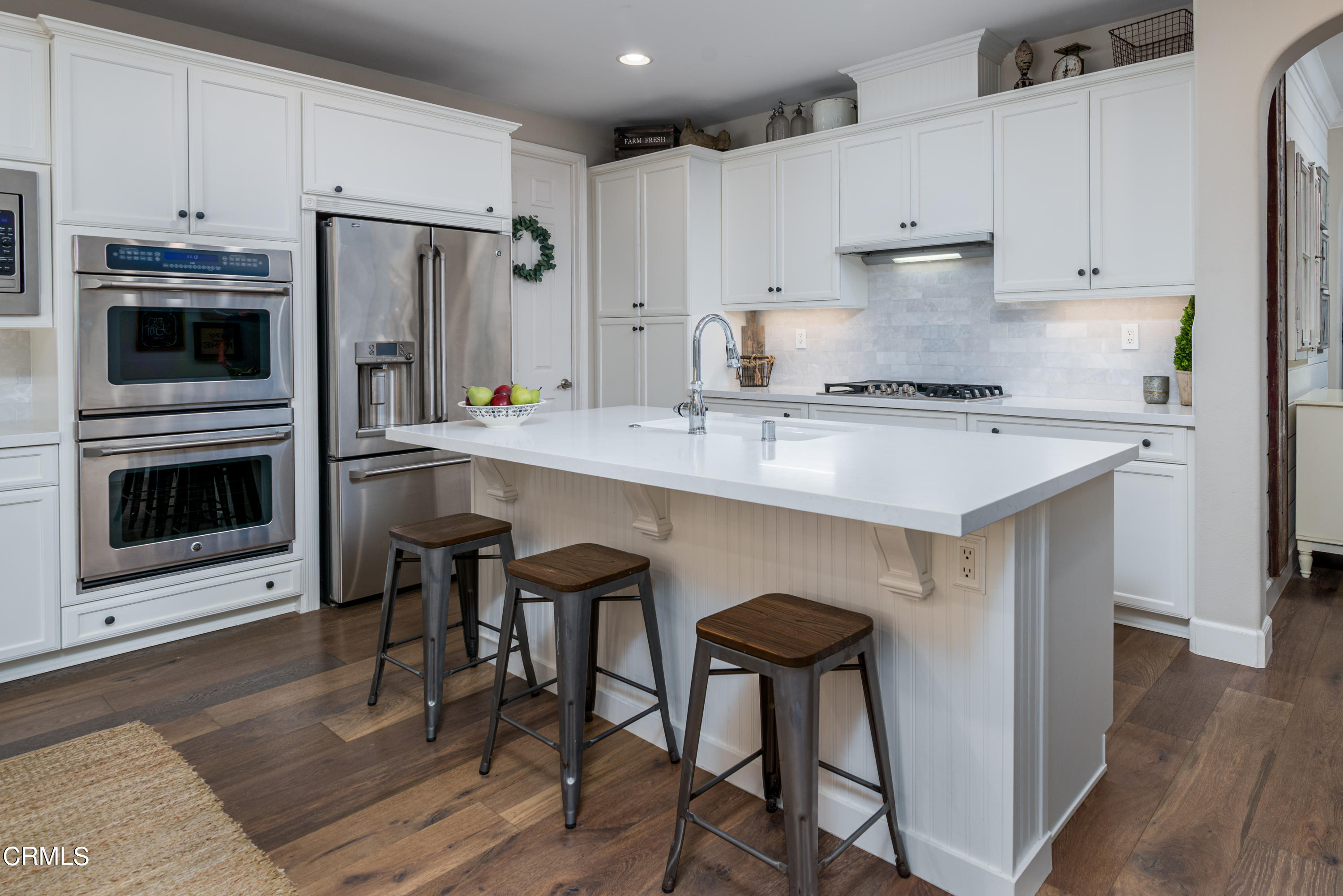 3064 White Rock Road Camarillo, CA 93012 - Photo 3 of 47 a kitchen with stainless steel appliances a stove a sink refrigerator and a refrigerator with wooden floor