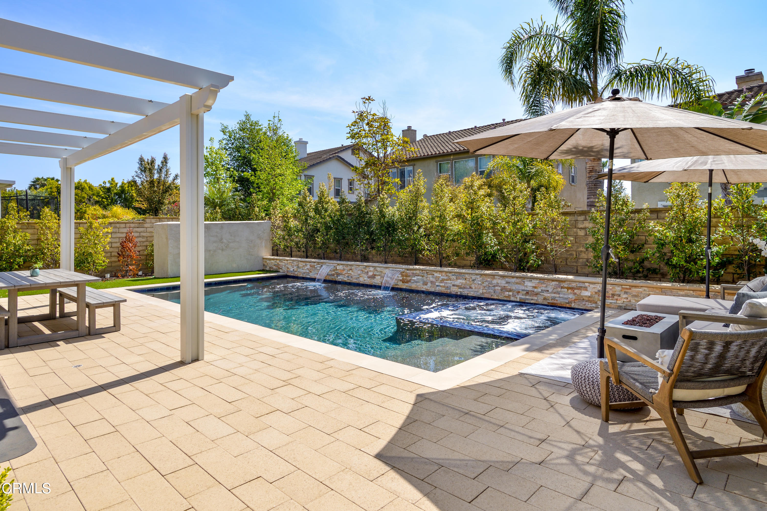 3064 White Rock Road Camarillo, CA 93012 - Photo 29 of 47 a view of a patio with couches table and chairs under an umbrella