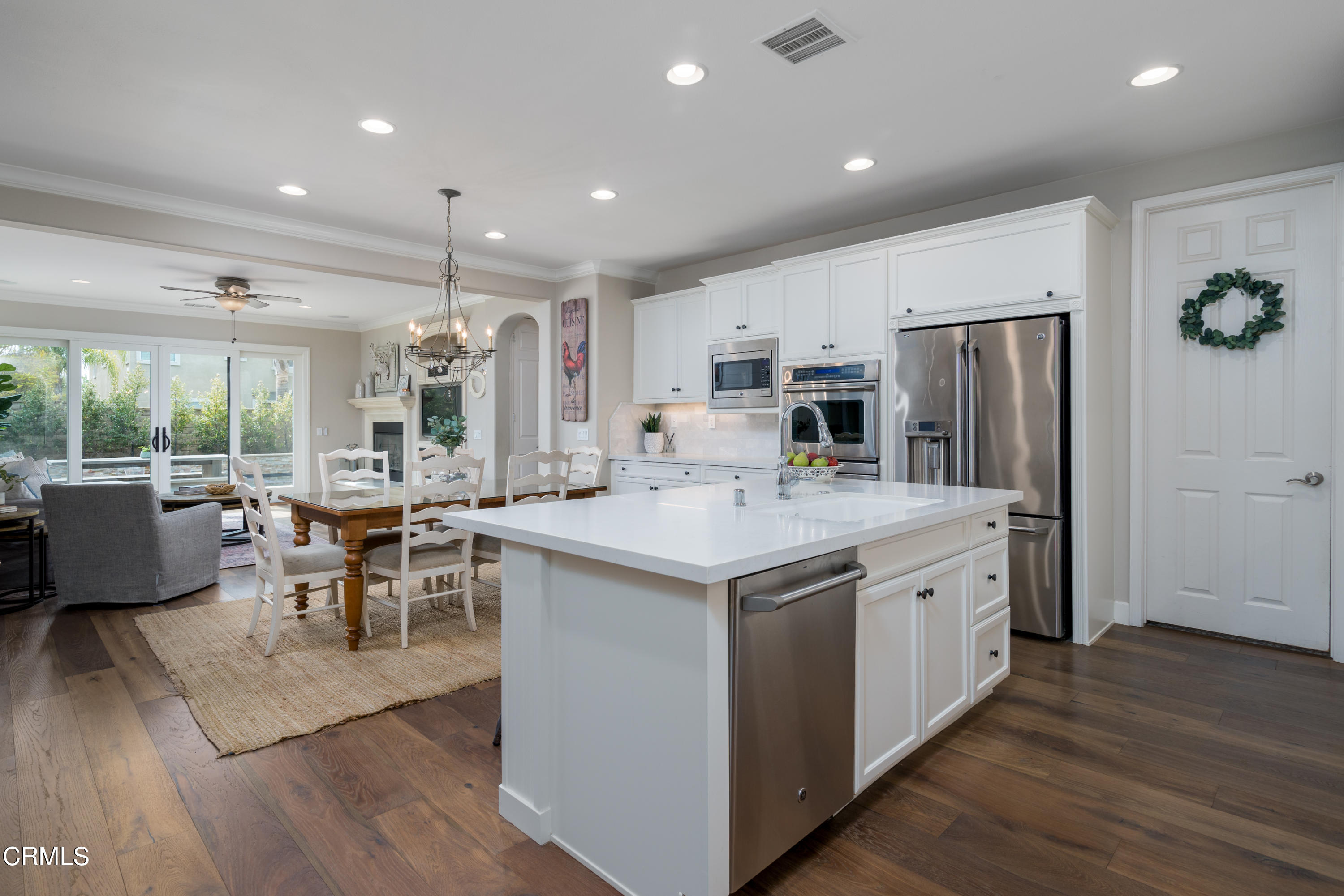 3064 White Rock Road Camarillo, CA 93012 - Photo 47 of 47 a kitchen with stainless steel appliances granite countertop a refrigerator a stove top oven a sink island and couches with wooden floor
