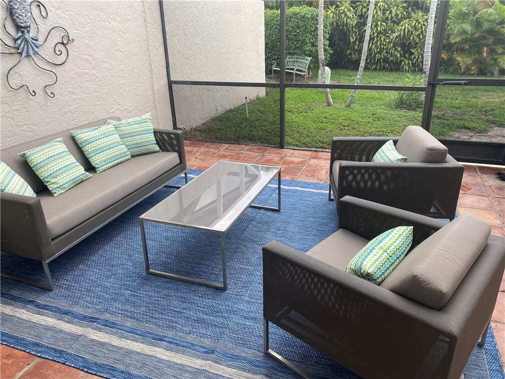 23336 Water Circle Boca Raton, FL 33486 - Photo 29 of 50 a view of a patio with couches chairs and a yard