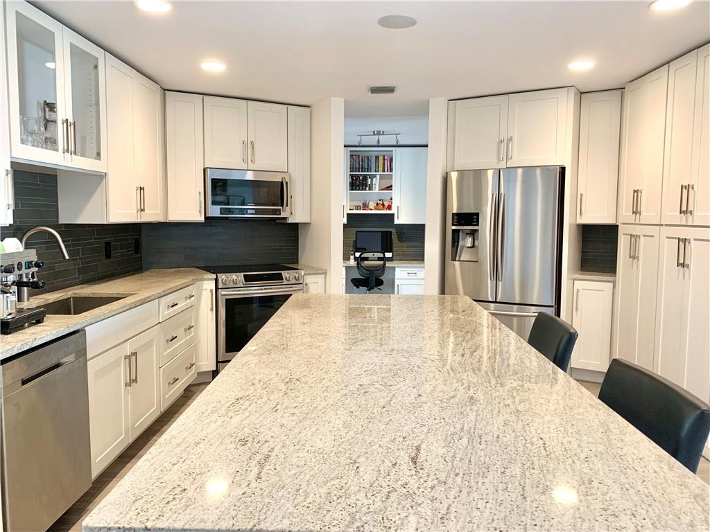 23336 Water Circle Boca Raton, FL 33486 - Photo 5 of 50 a large kitchen with granite countertop a large counter top stainless steel appliances and cabinets