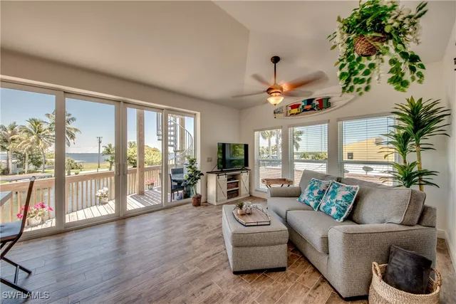a living room with furniture fireplace and a large window