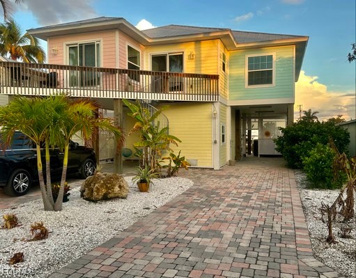 2579 Third Street Matlacha, FL 33993 - Photo 2 of 46 a view of a brick house with many windows and a yard