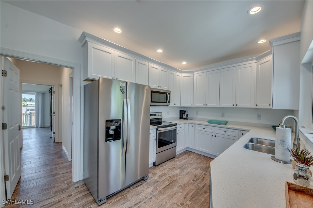 2579 Third Street Matlacha, FL 33993 - Photo 22 of 46 a kitchen with a refrigerator a sink and cabinets
