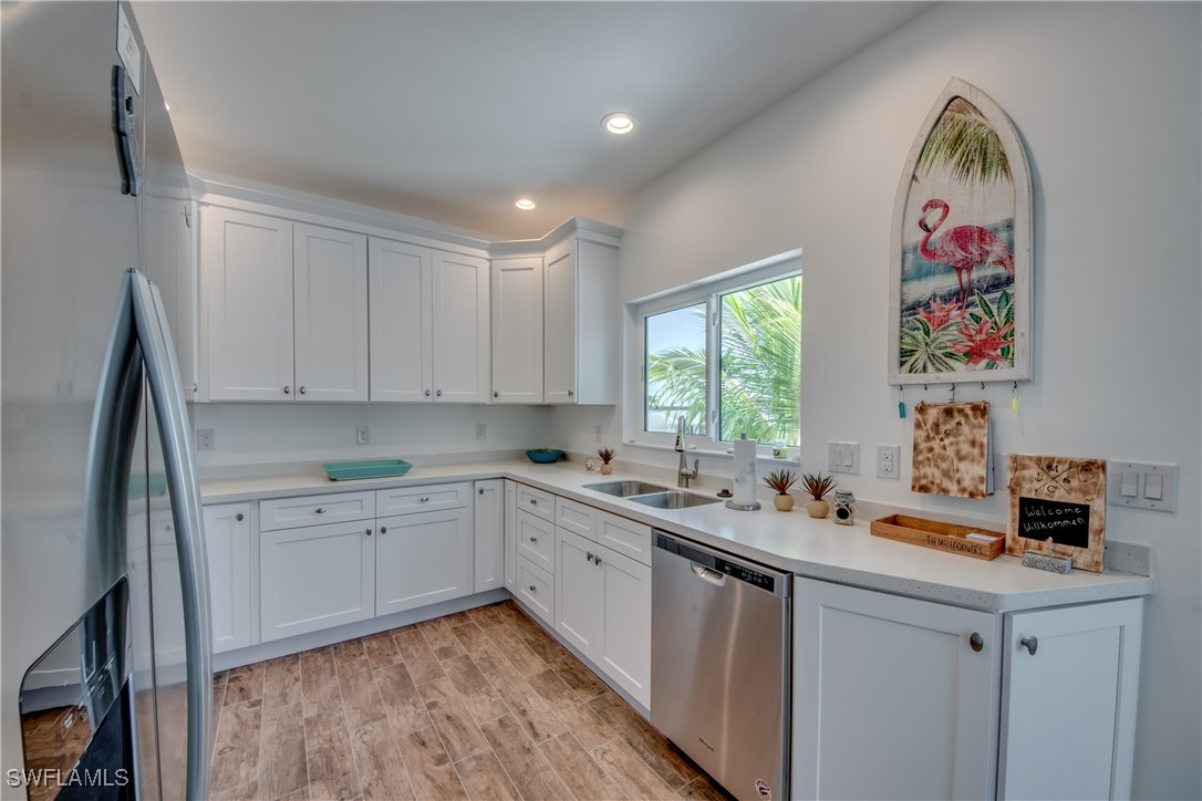 2579 Third Street Matlacha, FL 33993 - Photo 23 of 46 a kitchen that has a lot of cabinets a sink and a window