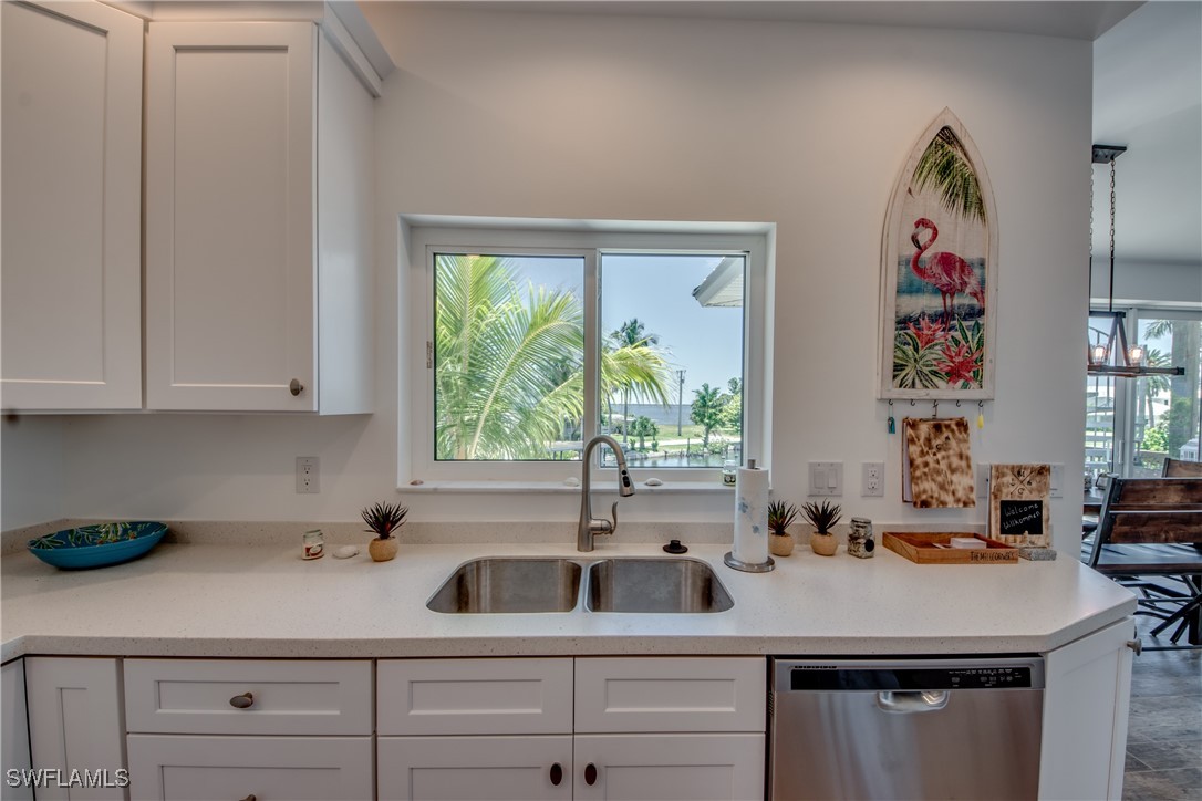 2579 Third Street Matlacha, FL 33993 - Photo 24 of 46 a kitchen with a sink and cabinets