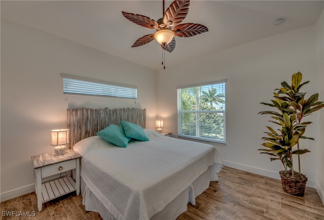 2579 Third Street Matlacha, FL 33993 - Photo 25 of 46 a bedroom with a bed potted plant on table and a window