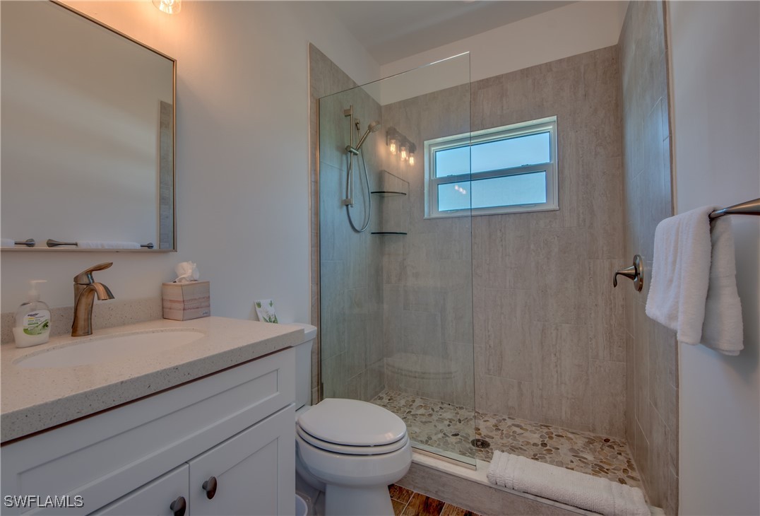2579 Third Street Matlacha, FL 33993 - Photo 26 of 46 a bathroom with a sink a toilet and shower