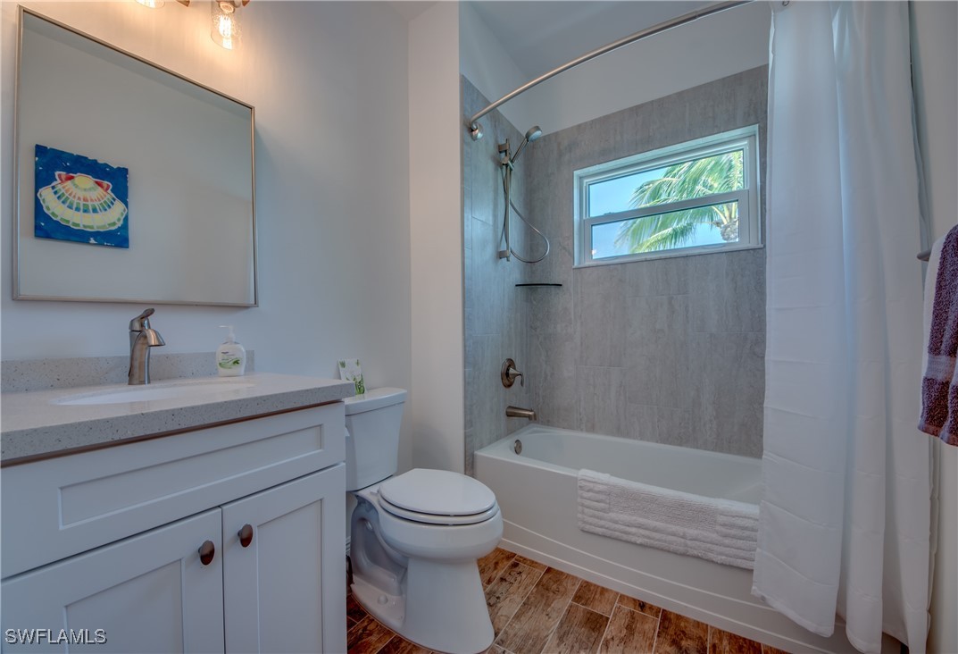 2579 Third Street Matlacha, FL 33993 - Photo 28 of 46 a bathroom with a toilet a sink and bathtub