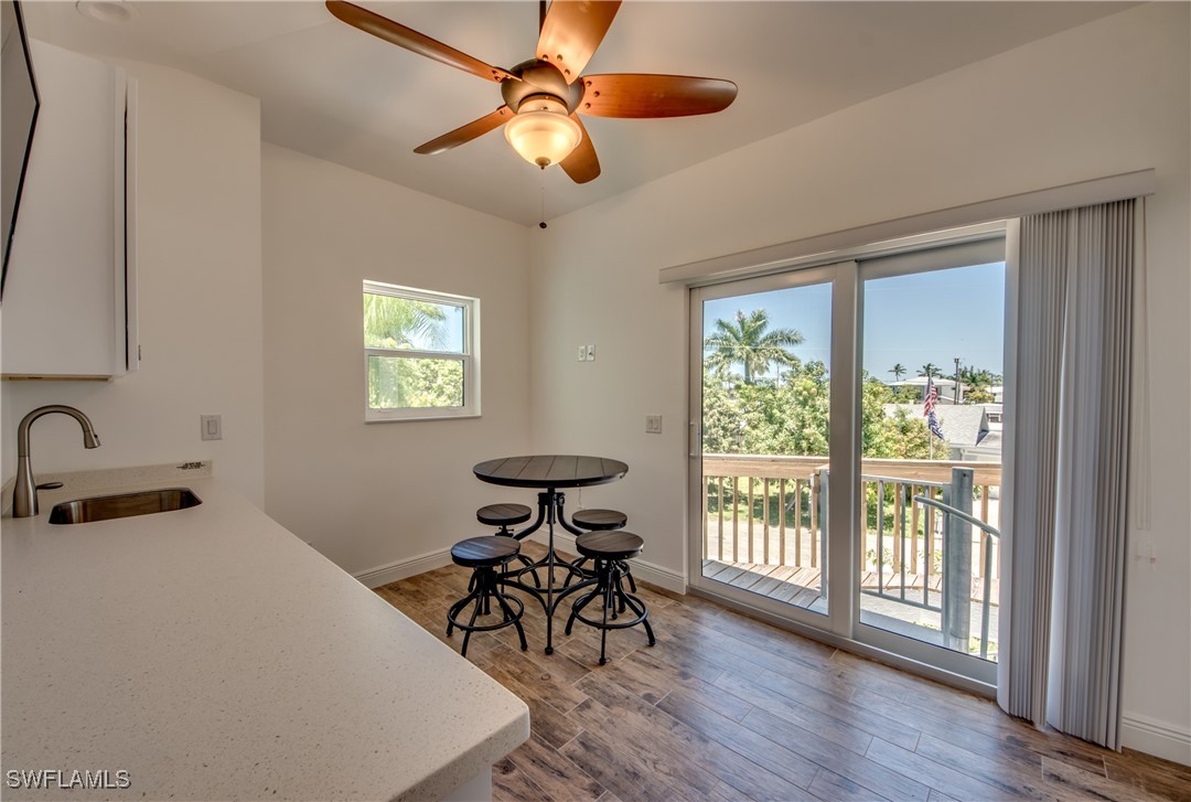 2579 Third Street Matlacha, FL 33993 - Photo 32 of 46 a bedroom with furniture window and wooden floor
