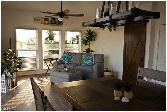 a living room with furniture and a floor to ceiling window