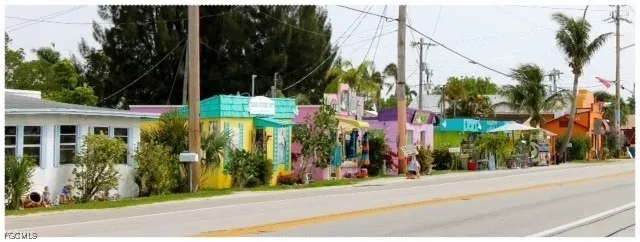 a view of street along with house and trees