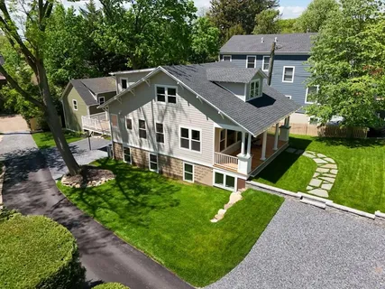 a aerial view of a house with a yard table and chairs