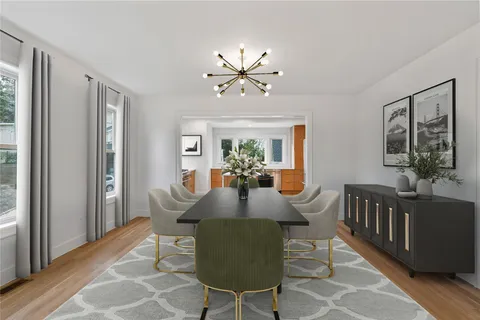 a kitchen with stainless steel appliances granite countertop a refrigerator a stove and a wooden floors