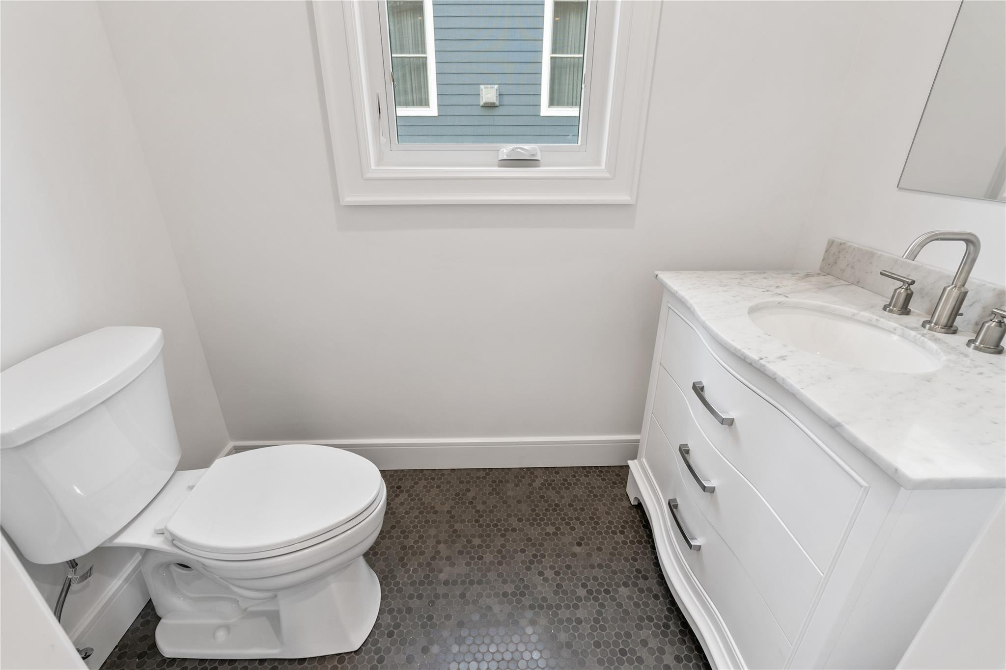 68 Glenlawn Avenue Sea Cliff, NY 11579 - Photo 19 of 49 a white toilet sitting next to a bathroom sink