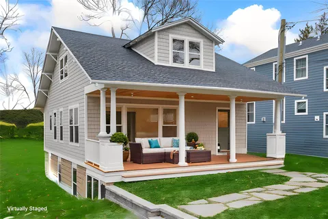 a front view of a house with a yard table and chairs