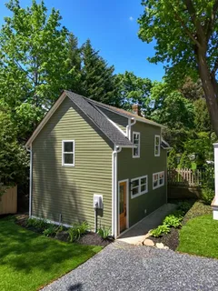 a front view of a house with a yard table and chairs