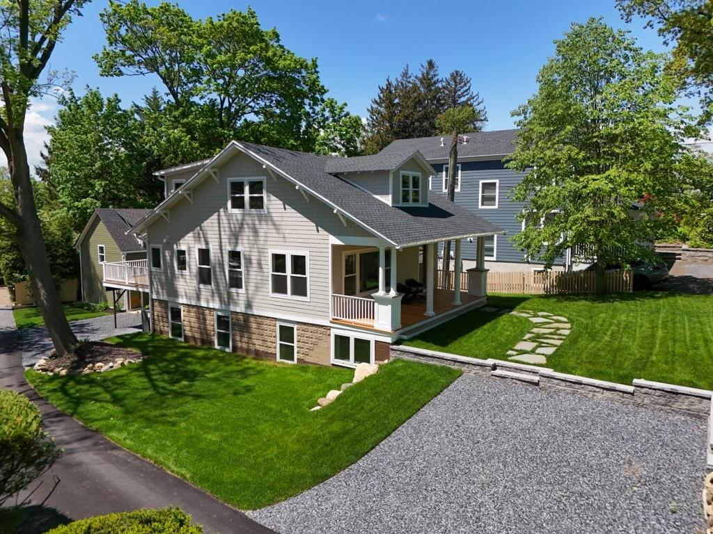 68 Glenlawn Avenue Sea Cliff, NY 11579 - Photo 7 of 49 a front view of a house with a yard table and chairs