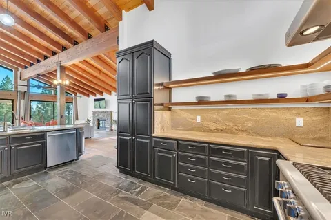 a kitchen with stainless steel appliances granite countertop a sink and cabinets