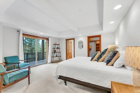 a bedroom with a bed and glass walk in closet