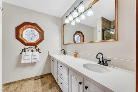 a bathroom with a sink a mirror and a lamp