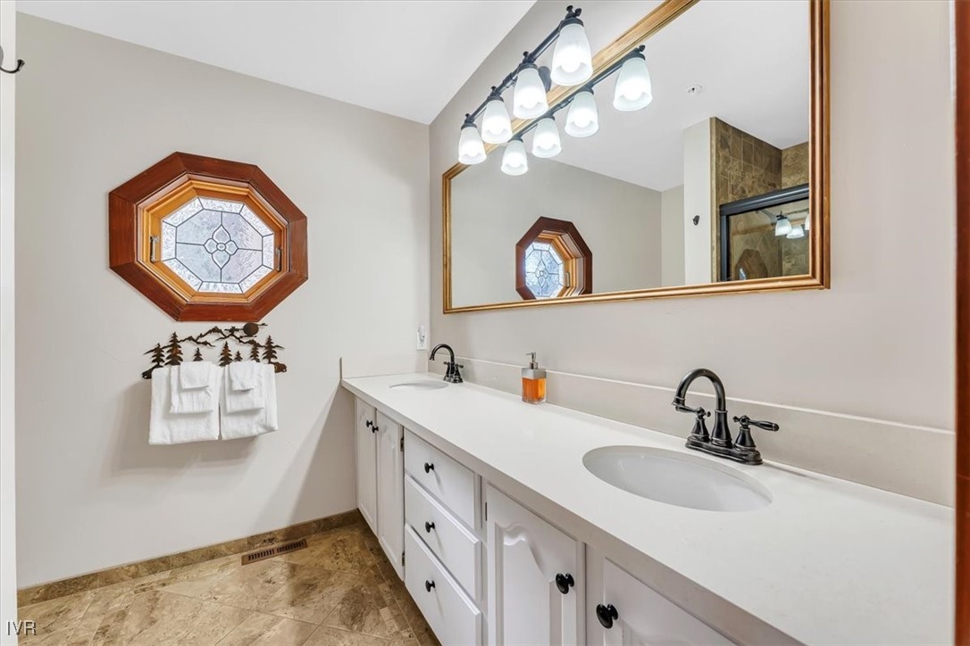 553 Silvertip Drive Incline Village, NV 89451 - Photo 29 of 35 a bathroom with a sink a mirror and a lamp