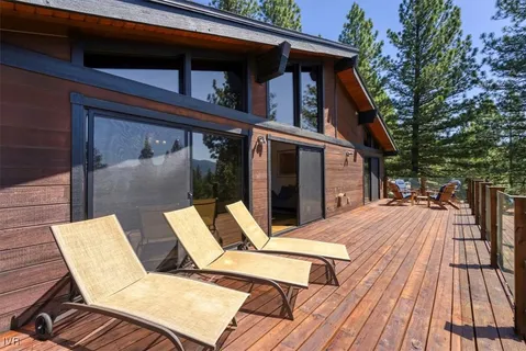 a view of backyard with two chairs and wooden floor