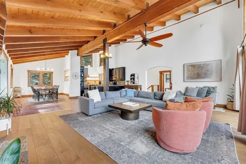 a living room with patio furniture and a wooden floor