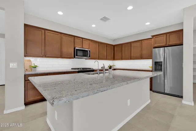 a kitchen with granite countertop a stove and a microwave