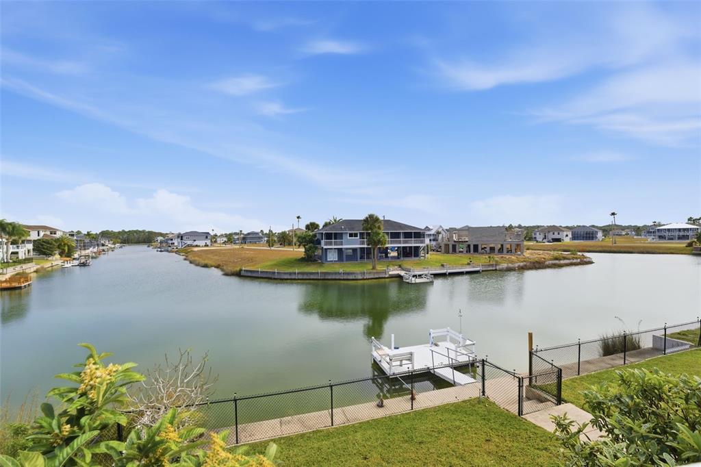 3366 Bluefish Drive Hernando Beach, FL 34607 - Photo 34 of 75 a view of a lake with a table and chairs