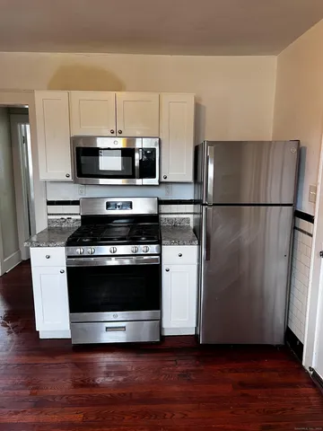 a kitchen with a refrigerator and a microwave
