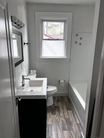 a bathroom with a sink toilet and tub