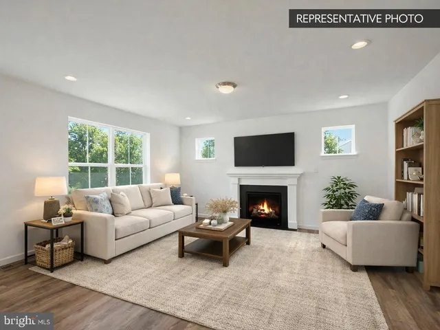a living room with furniture a fireplace and a large window