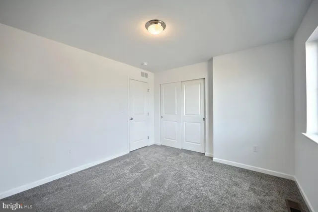 a bathroom with a sink a toilet a mirror a vanity and shower
