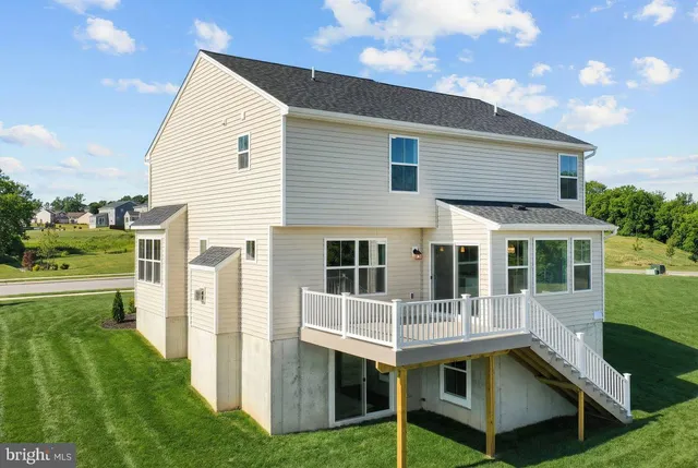 a view of a house with backyard porch and sitting area
