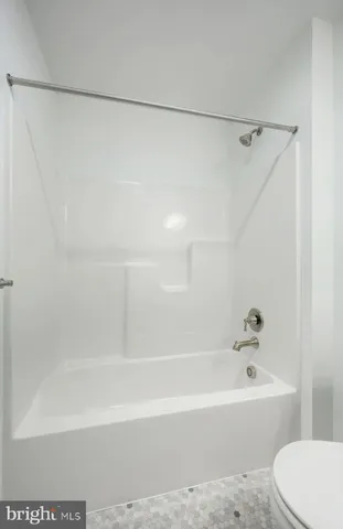 a white toilet sitting next to a bathroom sink