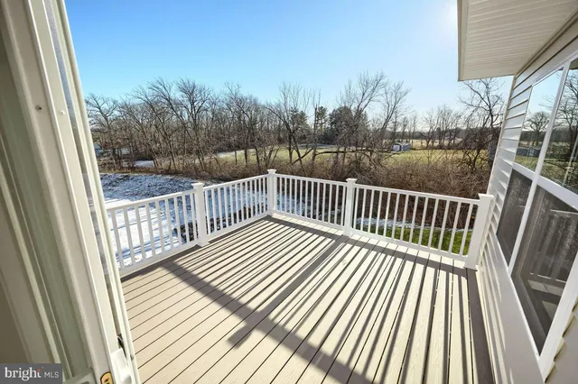 a view of balcony with wooden floor and fence