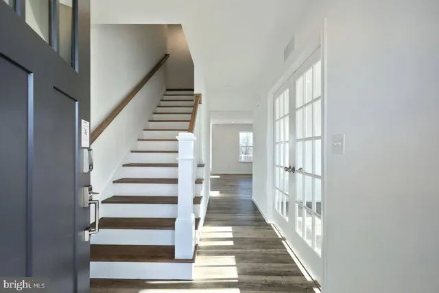 a view of staircase with wooden floor and windows