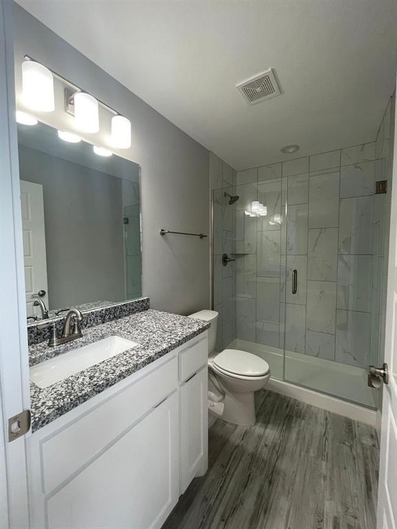 1315 West Gandy Street Denison, TX 75020 - Photo 12 of 19 a bathroom with a granite countertop sink toilet and shower